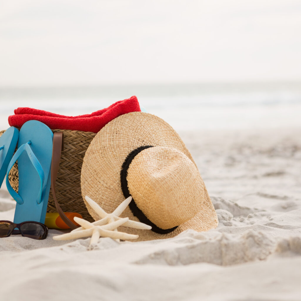 Bag and beach accessories kept on sand